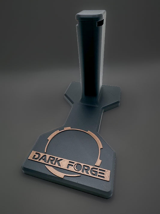 Darkforge Wraith and Reaper 2011 display stand with black shaped base and bronze-tone Dark Forge logo on a charcoal background