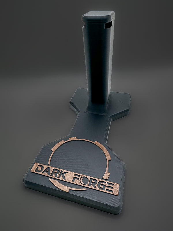 Darkforge Wraith and Reaper 2011 display stand with black shaped base and bronze-tone Dark Forge logo on a charcoal background