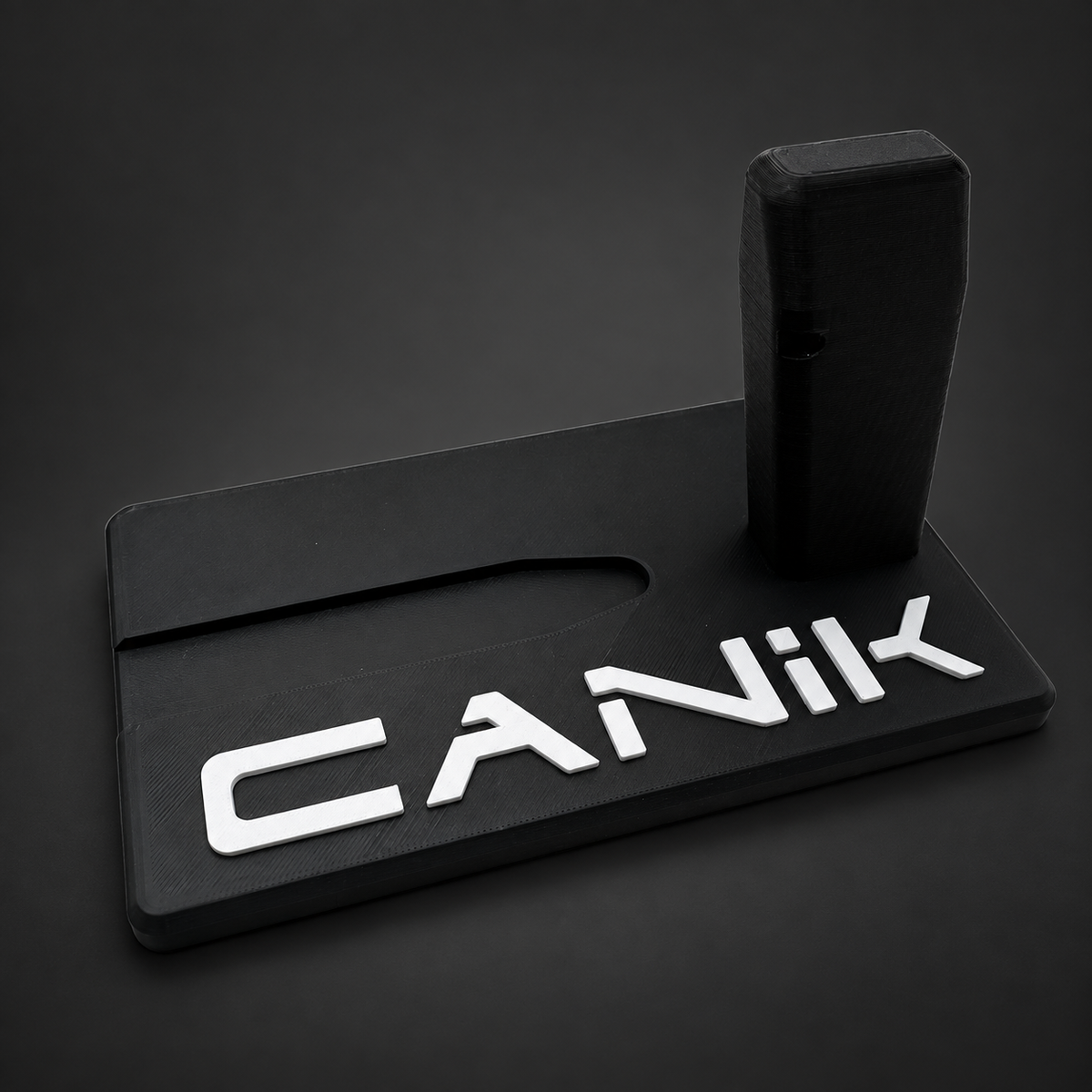 Canik Mete Series and TT Combat display stand, black polymer with raised white CANIK lettering on a charcoal background, angled front view