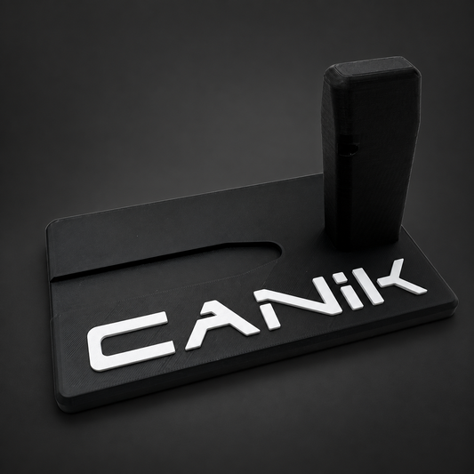 Canik Mete Series and TT Combat display stand, black polymer with raised white CANIK lettering on a charcoal background, angled front view