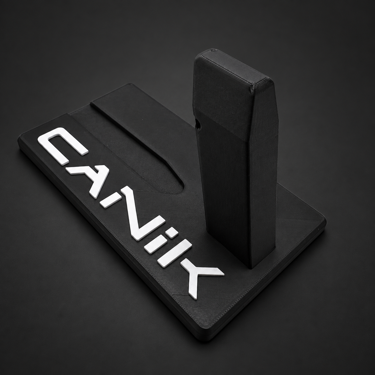 Angled side view of the Canik Mete Series and TT Combat black polymer display stand, showing the support post and white CANIK lettering