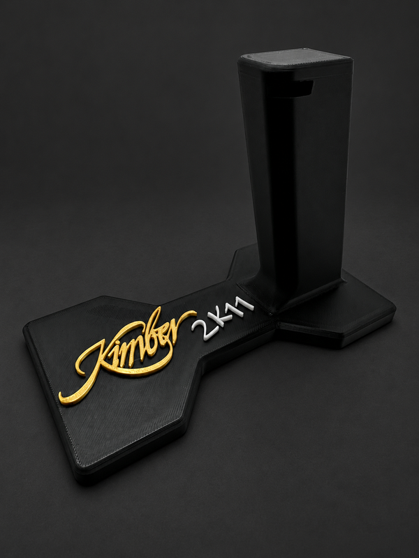 Kimber 2K11 Display Stand & Safe Organizer, black polymer stand with gold and white markings on a charcoal background
