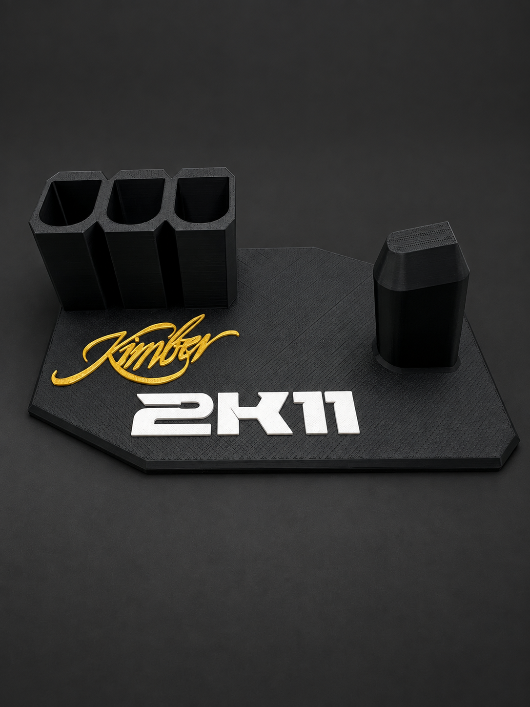 Kimber 2K11 Black & Gold Display Stand – 3 Magazine Holders, black polymer stand with gold and white markings on a charcoal background