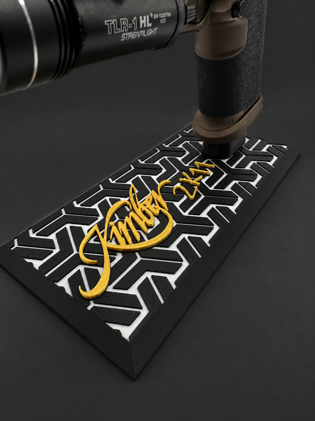 Kimber 2K11 Mag-Catch Display Stand – All Models, black polymer stand with gold and white markings on a charcoal background