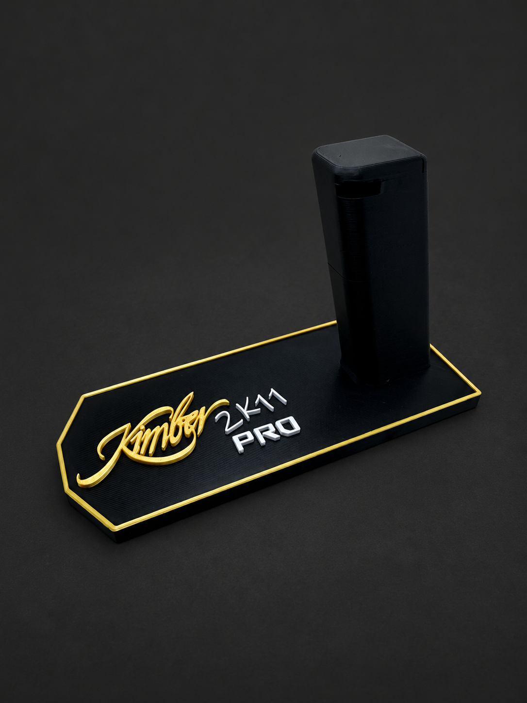 Kimber 2K11 Pro Display Stand – Polymer Mag-Lock, black polymer stand with gold and white markings on a charcoal background