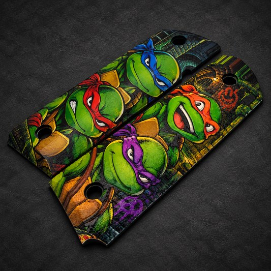 Teenage Mutant Ninja Turtles full-size 1911 ambi-cut polymer grip pair on charcoal background