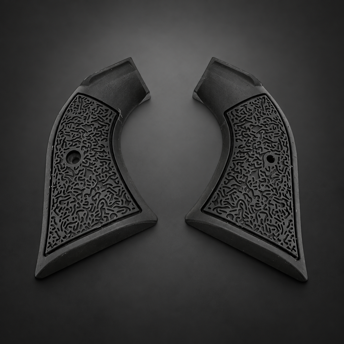 Black MicroMaze polymer Ruger Wrangler grip pair on a charcoal studio background